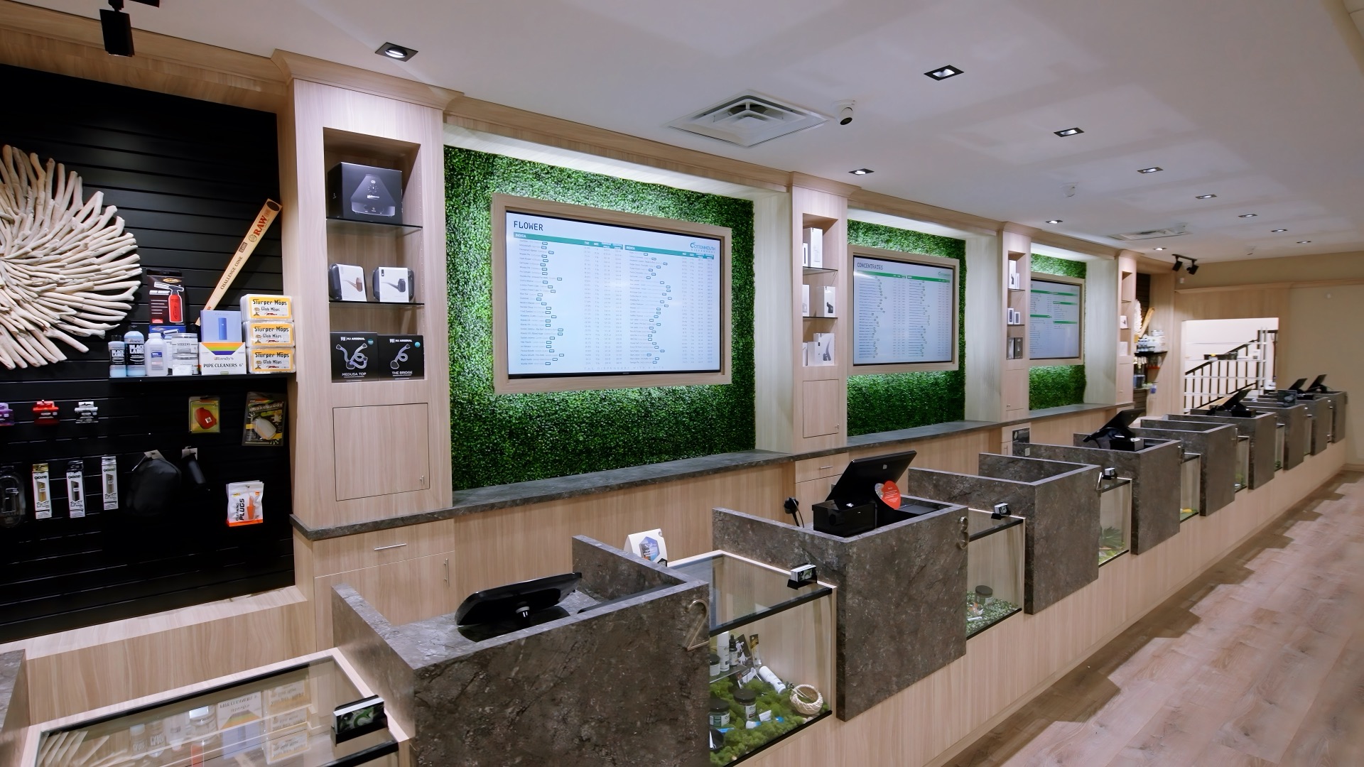 The Cottonmouth Dispensary sales counter with live menu boards above the flower cases
